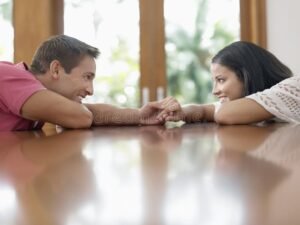 casal feliz segurando maos com vista juridica