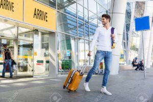 jovem feliz com malas em aeroporto internacional