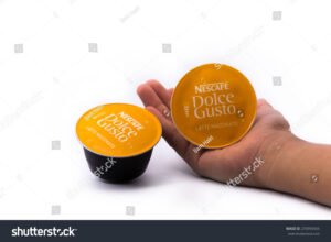 maos segurando capsulas dolce gusto coloridas